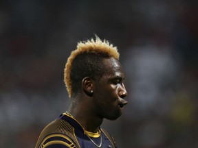 Kolkata Knight Riders' Andre Russell gestures as he walks to take his fielding position during the VIVO IPL Twenty20 cricket match against Royal Challengers Bangalore in Bangalore, India, Sunday, April 29, 2018.