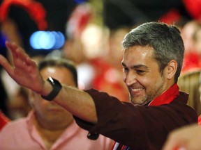 Presidential candidate Mario Abdo Benitez, of the Colorado Part,y waves to supporters during a campaign rally in Paraguari, Paraguay, Wednesday, April 18, 2018. Known by his nickname "Marito," the ruling party candidate is leading in the polls for the upcoming April 22 general elections.
