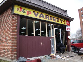 A restoration crew begins repairs at J&P Variety on Ingersoll Avenue in Woodstock, Ont. The store suffered roughly $250,000 in damage when thieves back an SUV through its entrance to gain access to its ATM.