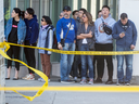 People watch the scene along Yonge Street after a man drove a rental truck down the sidewalk killed multiple pedestrians in Toronto, April 23, 2018.