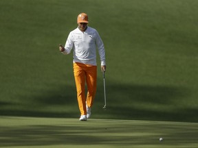 Rickie Fowler walks to his ball on the 10th hole during the fourth round at the Masters golf tournament Sunday, April 8, 2018, in Augusta, Ga.