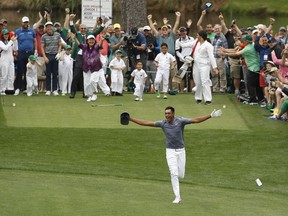 Tony Finau reacts after hitting a hole in one on the seventh home during the par three competition at the Masters golf tournament Wednesday, April 4, 2018, in Augusta, Ga.