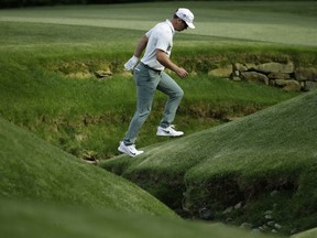 Paul Casey, of England, crosses Rae's Creek on the 13th hole during the second round at the Masters golf tournament Friday, April 6, 2018, in Augusta, Ga.