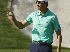 Haotong Li, of China, reacts after a birdie on the 16th hole during the first round at the Masters golf tournament Thursday, April 5, 2018, in Augusta, Ga.