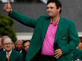 Patrick Reed gives a thumbs up after being presented with the championship trophy after winning the Masters golf tournament Sunday, April 8, 2018, in Augusta, Ga.