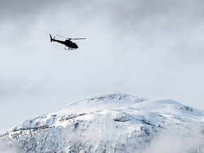 File photo of a search and rescue helicopter over mountains in British Columbia.