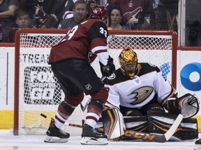 Anaheim Ducks goalie Ryan Miller deflects the puck from Arizona Coyotes' Alex Goligoski during the first period of an NHL Hockey game Saturday, April 7, 2018, in Glendale, Ariz.