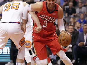 New Orleans Pelicans forward Nikola Mirotic (3) drives past Phoenix Suns forward Dragan Bender (35) during the first half of an NBA basketball game Friday, April 6, 2018, in Phoenix.