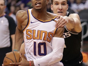 Phoenix Suns guard Shaquille Harrison (10) drive as Sacramento Kings guard Bogdan Bogdanovic defends during the second half of an NBA basketball game Tuesday, April 3, 2018, in Phoenix.