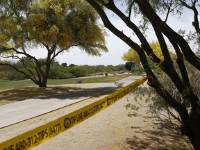 Police tape cordon off an area near the site of a plane crash that killed several people Tuesday, April 10, 2018, in Scottsdale, Ariz. A National Transportation Safety Board investigator is at the scene of the deadly crash and authorities are working to identify the people killed in a Piper PA-24 Comanche that went down Monday night shortly after takeoff from the Scottsdale Airport.