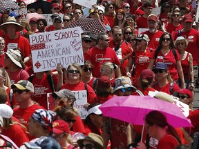 Thousands march to the Arizona Capitol for higher teacher pay and public school funding on the first day of a state-wide teachers strike Thursday, April 26, 2018, in Phoenix. Arizona leaders dealing with an unprecedented teacher strike are paying the political price for long-festering resentment among many public school teachers.