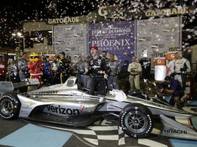 Josef Newgarden celebrates after winning an IndyCar auto race Saturday, April 7, 2018, at Phoenix International Raceway in Avondale, Ariz.