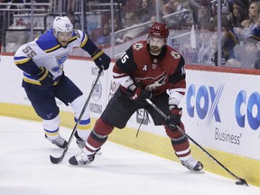 Arizona Coyotes center Brad Richardson (15) shields St. Louis Blues defenseman Colton Parayko from the puck in the second period during an NHL hockey game, Saturday, March 31, 2018, in Glendale, Ariz.