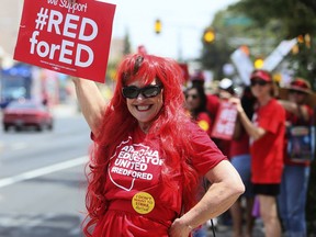 "It's our day to be noticed," says Beatrice Goldsmith as she joins approximately a thousand teachers, other staff and supporters on Congress Street at Granada Avenue in Tucson, Ariz., on the first day of the statewide teacher walkout on April Thursday, 26, 2018.