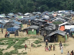 Rohingya refugees gather near their shelters in the "no man's land" behind Myanmar's boder lined with barb wire fences in Maungdaw district, Rakhine state bounded by Bangladesh on April 25, 2018.