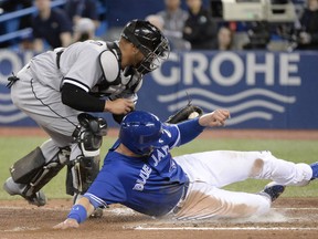Chicago White Sox catcher Welington Castillo tags out the Blue Jays' Justin Smoak  at home plate during the  sixth inning of their game at Rogers Centre in Toronto on Wednesday night.