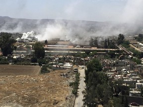 Smoke rises after Syrian government airstrikes and shelling hit in Hajar al-Aswad neighborhood held by Islamic State militants, southern Damascus, Syria, Tuesday, April 24, 2018. Syrian state TV is reporting that government forces have launched a new operation targeting underground tunnels used by the Islamic State group in the capital, Damascus. (AP Photo)