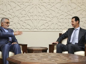 In this photo released by the Syrian official news agency SANA, Syrian President Bashar Assad, right, meets with Alaeddin Boroujerdi, left, the head of Iran's parliamentary committee on national security and foreign policy, in Damascus, Syria, Monday, April 30, 2018. The meeting came as a missile attack targeting government outposts in Syria's northern region killed at least 26 pro-government fighters, mostly Iranians, amid soaring Mideast tensions. (SANA via AP)