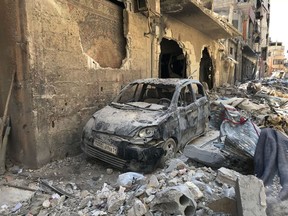 Rubble lines a street in Douma, the site of a suspected chemical weapons attack, near Damascus, Syria, Monday, April 16, 2018. Faisal Mekdad, Syria's deputy foreign minister, said on Monday that his country is "fully ready" to cooperate with the fact-finding mission from the Organization for the Prohibition of Chemical Weapons that's in Syria to investigate the alleged chemical attack that triggered U.S.-led airstrikes.
