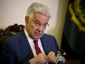 FILE - In this April 2, 2018, file photo, Pakistan's Foreign Minister Khawaja Mohammad Asif listens to a reporter at the Foreign Ministry in Islamabad, Pakistan. A Pakistani court has disqualified the country's foreign minister from holding office after a petition from a rival politician sought his removal for concealing assets abroad.