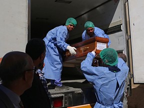 A casket holding one of 38 Indians abducted by the Islamic State group in 2014, that were found in a mass grave outside Mosul, is loaded on a truck to be transported from Baghdad's main morgue to the Baghdad airport, in Iraq, Sunday, April 1, 2018. The remains of the Indian construction workers captured and killed by IS militants in northern Iraq have been handed over to Indian authorities in Baghdad and will be flown home.