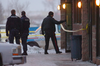 Police investigate a triple-murder at the Bolsa Restaurant in Calgary, Jan. 1, 2009.