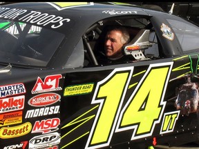 FILE - In this July 6, 2017 file photo, Vermont Gov. Phil Scott waits to take his stock car out for a practice run at the Thunder Road race track in Barre, Vt. A spokeswoman for Scott said the stock-car-racing governor is questioning whether to race in 2018 at the speedway where many spectators are hunters, after a public outcry over gun restriction legislation he signed on April 11, 2018.