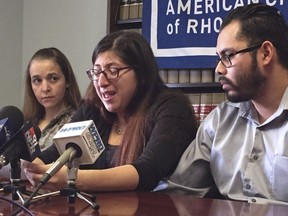 FILE - In this Feb. 14, 2018, file photo, Lilian Calderon, center, cries as she describes her experiences while in custody, alongside her husband, Luis Gordillo, right, during a news conference at the office of the American Civil Liberties Union in Providence, R.I. Calderon was detained by Immigration and Customs Enforcement after an interview designed to confirm her marital relationship. A judge stayed her deportation. The American Civil Liberties Union of Massachusetts filed class action lawsuit, which includes Calderon, Wednesday, April 11, against President Donald Trump over the government's practice of detaining immigrants married to U.S. citizens while they are trying to obtain lawful immigration status.