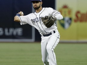 San Diego Padres second baseman Carlos Asuaje throws out Colorado Rockies' Carlos Gonzalez on a ground ball during the first inning of a baseball game in San Diego, Tuesday, April 3, 2018.