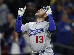 Los Angeles Dodgers' Max Muncy reacts after hitting a two-run home run during the third inning of a baseball game against the San Diego Padres on Wednesday, April 18, 2018, in San Diego.