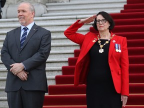 Premier John Horgan looks on as Lieutenant-governor Janet Austin salutes the 100-person Guard of Honour following the installation ceremony at Legislature in Victoria on Tuesday April 24, 2018.