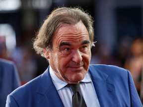 FILE - In this Aug. 13, 2017 file photo, American screenwriter, film director, and producer, Oliver Stone, walks on the red carpet to receive the Sarajevo Film Festival's top honor, the Heart of Sarajevo Award, in Sarajevo. Iranian media are saying director Oliver Stone has arrived Tehran to attend an international film festival. The Monday, April 22, 2018 report by the semi-official Tasnim news agency says Stone briefly visited historical city of Isfahan a day earlier. Stone will host a workshop for filmmakers during the festival. He will have a news conference later on Wednesday. This is the first visit by Stone to Iran.