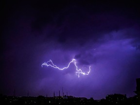 In this Tuesday, April 24, 2018 photo, lightning flashes over old Cairo, Egypt.