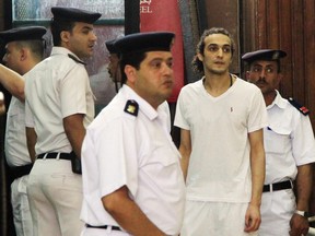 FILE - In this May 14, 2015 file photo, Egyptian photojournalist Mahmoud Abu Zied, known by his nickname Shawkan, second right, appears before judge for the first time after spending more than 600 days in prison in Cairo, Egypt. A statement Tuesday, April 10, 2018, by Human Rights Watch, a leading international rights group, urged Egypt's President Abdel Fatah el-Sissi to prioritize reforms aimed at ending human rights abuses during his second, four-year term in office. The statement also called on Egypt's allies to push el-Sissi to end a crackdown on non-governmental organizations and enforced disappearances, release political prisoners and journalists and protect minorities.