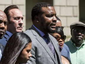 Lee Merritt, center, leads a news conference, Monday, April 23 2018, in San Bernardino, Calif., announcing a series of lawsuits against the Barstow Police Department regarding the shooting death of Diante "Butchie" Yarber. Family members and attorneys are disputing the official account of the fatal police shooting of Yarber, a 26-year-old black man, during a traffic stop earlier in the month in Barstow, Calif.