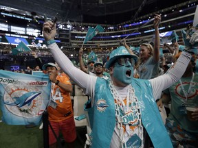 Miami Dolphins fans cheer during the second round of the NFL football draft, Friday, April 27, 2018, in Arlington, Texas.