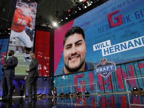 Former New York Giants player Justin Tuck, left, makes his team's selection as NFL Commissioner Roger Goodell, right, applauds during the second round of the NFL football draft Friday, April 27, 2018, in Arlington, Texas. The Giants selected UTEP's Will Hernandez.