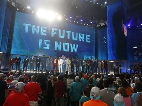 Prospects in attendance stand on stage at the start of the first round of the NFL football draft, Thursday, April 26, 2018, in Arlington, Texas.