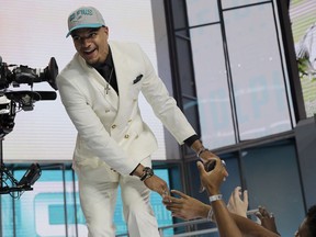 Alabama's Minkah Fitzpatrick walks on stage after being selected by the Miami Dolphins during the first round of the NFL football draft, Thursday, April 26, 2018, in Arlington, Texas.