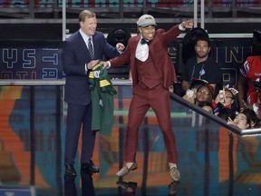 Commissioner Roger Goodell, left, watches as Louisville's Jaire Alexander celebrates after being selected by the Green Bay Packers during the first round of the NFL football draft, Thursday, April 26, 2018, in Arlington, Texas.