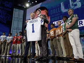 Commissioner Roger Goodell, center left, presents Boise State's Leighton Vander Esch with his Dallas Cowboys team jersey during the first round of the NFL football draft, Thursday, April 26, 2018, in Arlington, Texas.