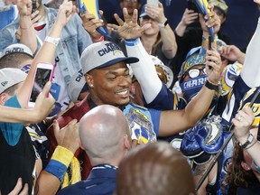 Florida State's Derwin James, center, celebrates with fans after being selected by the Los Angeles Chargers during the first round of the NFL football draft, Thursday, April 26, 2018, in Arlington, Texas.
