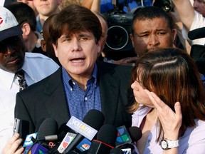 FILE - In this March 14, 2012, file photo, former Illinois Gov. Rod Blagojevich speaks to the media outside his home in Chicago as his wife, Patti, wipes away tears a day before he was to report to a prison after his conviction on corruption charges. On Monday, April 16, 2018, the U.S. Supreme Court rejected an appeal and let stand the convictions and 14-year prison term that Blagojevich is serving. He's scheduled to be released in 2024.