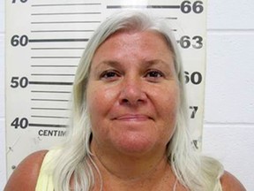 FILE - This file photo provided by the South Padre Island Police Department shows Lois Riess, of Blooming Prairie, Minn., who was arrested by federal deputy marshals April 19, 2018, at a restaurant in South Padre Island, Texas in connection with the killings of two people in separate states, including her husband. Riess will attend an extradition hearing Monday, April 23, 2018, to send her to Florida. (South Padre Island Police Department via AP, File)