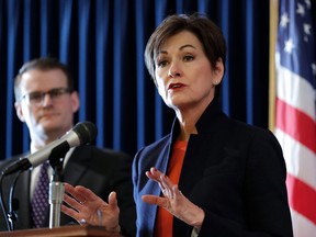 FILE - In this Jan. 8, 2018 file photo, Iowa Gov. Kim Reynolds speaks during a news conference as acting Lt. Gov. Adam Gregg, left, looks on during the opening day of the Iowa Legislature at the Statehouse in Des Moines, Iowa. An agency director fired by Reynolds had been accused of harassing female employees for years by routinely making crude sexual comments and pressuring one to go into his hotel room during work travel. Bowing to pressure after keeping the document secret for a month, the governor released a March 21 letter to her that laid out detailed allegations against Iowa Finance Authority Director Dave Jamison. The woman said Jamison talked about her breasts and constantly made sexual remarks.