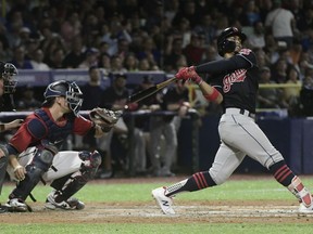 CORRECTS RIVAL TEAM TO MINNESOTA TWINS -  Cleveland Indians' infielder Francisco Lindor hits a home run against the Minnesota Twins during the fifth inning of game one of a two-game MLB Series at Hiram Bithorn Stadium in San Juan, Puerto Rico, Tuesday, April 17, 2018.