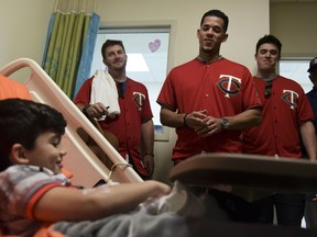 Lucas Suarez smiles during a visit from Minnesota Twins starting pitcher Jose Berrios, center, and a group of his teammates, at the San Jorge Children's Hospital in San Juan, Puerto Rico, Monday, April 16, 2018. Next Tuesday and Wednesday, the Cleveland Indians and the Minnesota Twins will meet in a two-game series at Hiram Bithorn Stadium in San Juan.