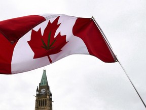 A Canadian flag with a marijuana leaf on it flies during a 4/20 rally on Parliament Hill in Ottawa, on Thursday, April 20, 2017.