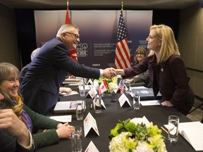 Public Safety Minister Ralph Goodale reaches across a table to shake hands with Kirstjen Nielsen, United States Secretary of Homeland Security during a G7 Foreign and Security Ministers meeting in Toronto on Monday, April 23, 2018.