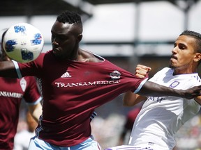 Colorado Rapids defender Bismark Adjei-Boateng, left, fights for control of the ball with Orlando City defender Mohamed El-Munir in the first half of an MLS soccer match Sunday, April 29, 2018, in Commerce City, Colo.
